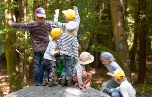 Kinder klettern auf einen großen Stein